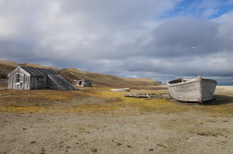 fishing cabin,norway,a small log cabin, a fishing hut with a beached boat.