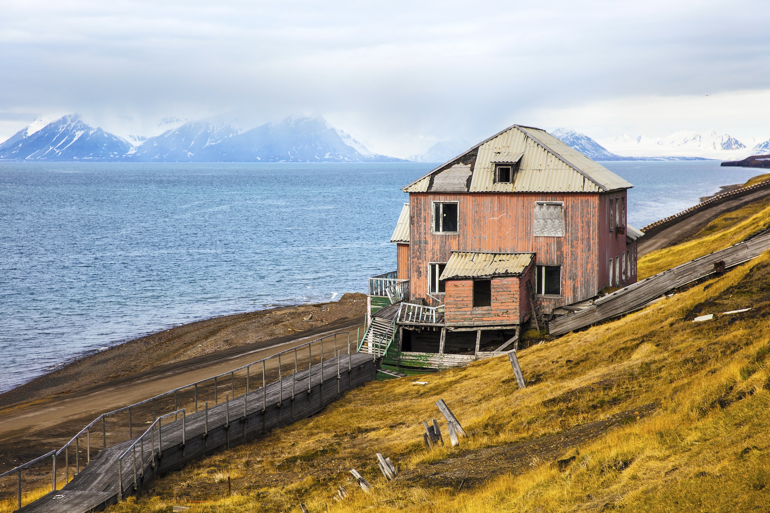 abandoned house in the harsh arctic nature at summer