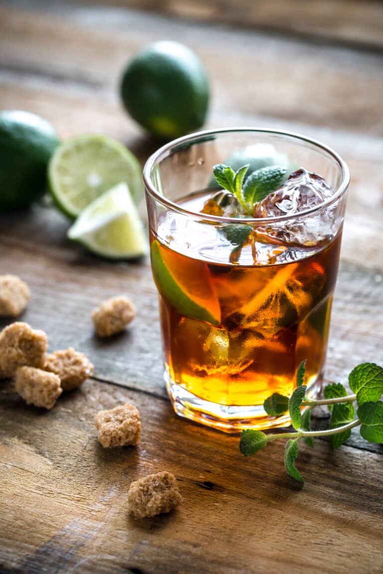 glass of rum on the wooden background