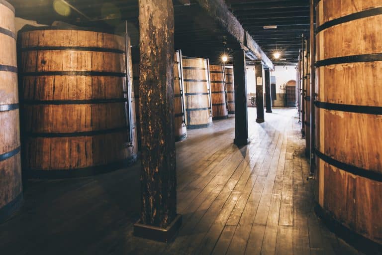 wine in wooden barrels stored for aging in the cellar